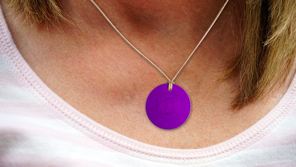 Example of use: The Tesla Purple Energy Medallion (Ø 4 cm) worn on the neck with a leather strap.